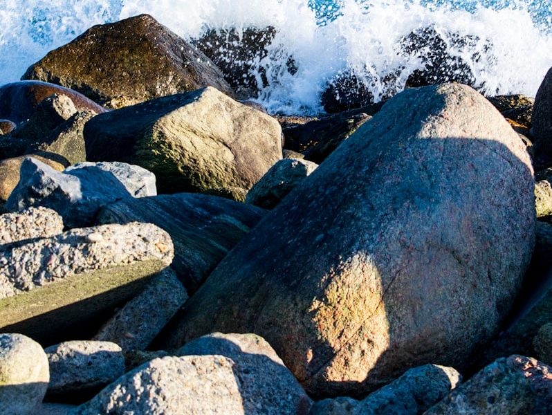 gray and brown rocks near body of water during daytime